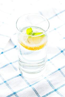 Close up of glass of herbal lemon water