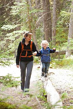 Caucasian mother and son hiking in forest