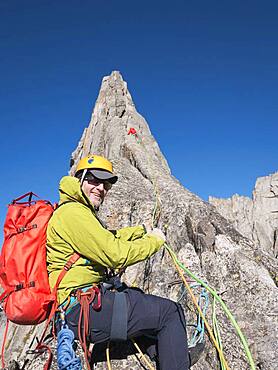 Caucasian climber smiling on mountainside