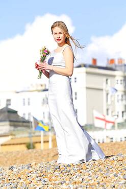 Woman holding bouquet on beach