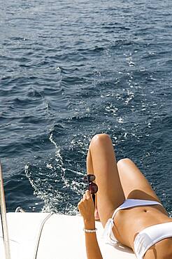 Woman wearing bikini on boat deck