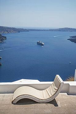 Lawn chair on hilltop overlooking ocean