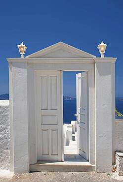 Door on hilltop over seascape