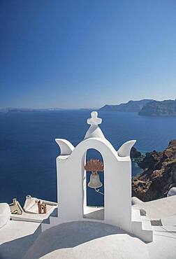 Church bell on hillside over seascape