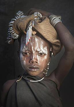 Black child wearing traditional face paint