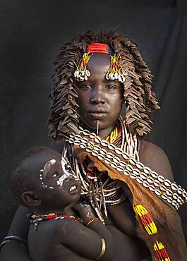 Black mother and daughter wearing traditional jewelry