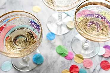 Confetti near glasses of champagne