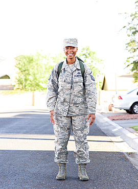 Portrait of black woman soldier standing in street