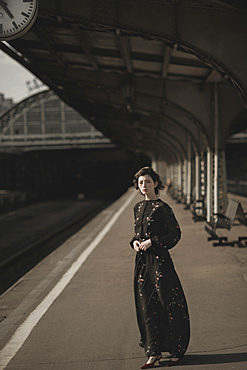 Caucasian woman waiting at train station