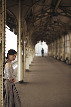 Portrait of serious Caucasian woman at train station