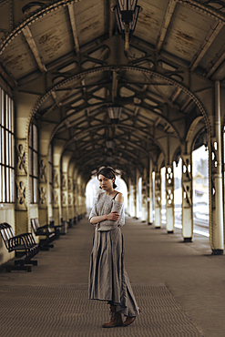 Portrait of serious Caucasian woman at train station