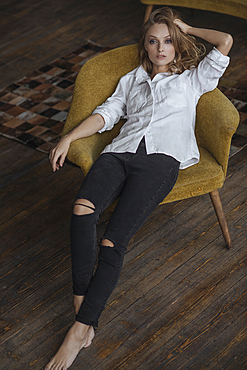 Portrait of Caucasian woman sitting in armchair