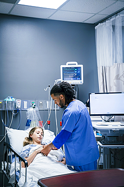 Nurse holding hand of patient in hospital