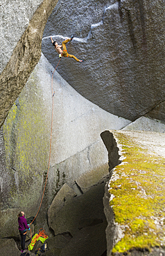 Girl watching boy rock climbing