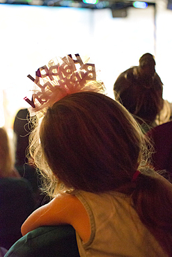 Rear view of Caucasian girl wearing birthday headband