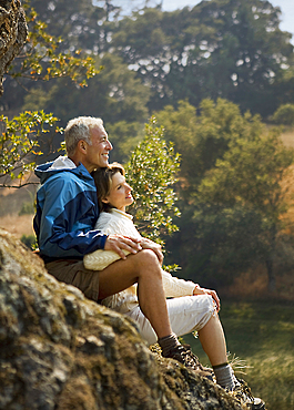 Couple sitting on rocks and relaxing