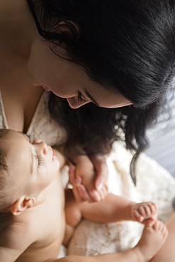 Caucasian mother playing with baby son