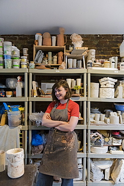 Caucasian woman standing in pottery workshop