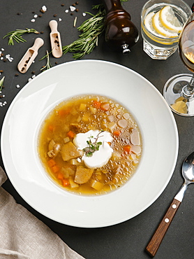 Brown soup in bowl with sour cream