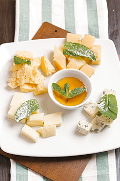 Variety of cheeses on plate with sauce