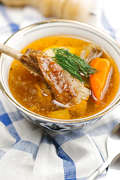 Garnish on bowl of soup with meat