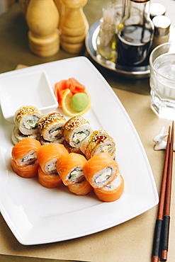 Sushi on plate with chopsticks