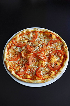 Gourmet pizza with tomatoes