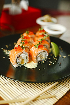 Sushi on plate with chopsticks