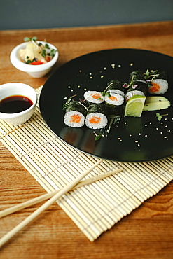 Chopsticks and sushi with sauce