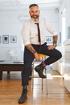 Portrait of smiling Caucasian businessman with tattoos