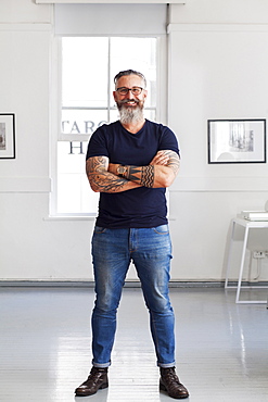 Portrait of smiling muscular Caucasian hipster man