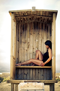 Caucasian woman sitting in cabana on beach