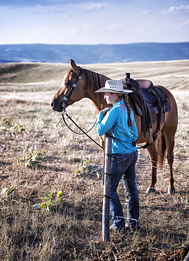 Caucasian girl standing in field with horse