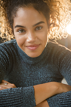 Smiling Mixed Race woman wearing sweater