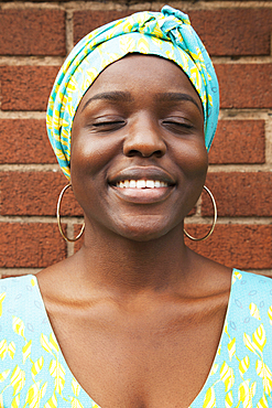 Portrait of smiling Black woman with eyes closed