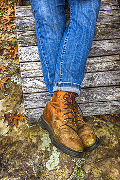 Legs of Caucasian woman wearing jeans and boots