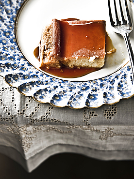 Flan on plate with syrup and fork