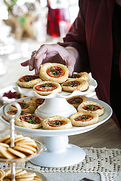 Hand holding holiday tart on tray