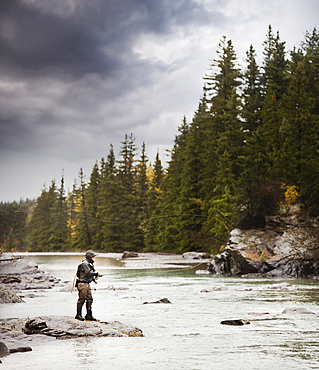 Caucasian man fishing at river