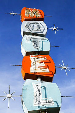 Old-fashioned motel sign under blue sky