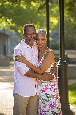 Black couple hugging in park