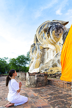 Asian woman praying at temple