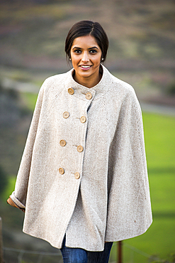 Portrait of smiling Indian woman wearing poncho