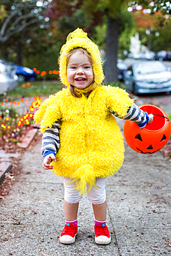 Smiling Caucasian girl wearing chicken costume on Halloween