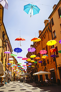 Multicolor umbrellas hanging over street, Bologna, Emilia-Romagna, Italy