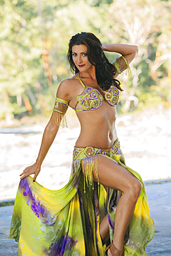 Belly dancer posing holding skirt