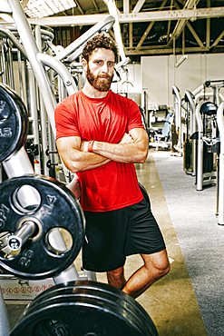 Serious Mixed Race man posing in gymnasium