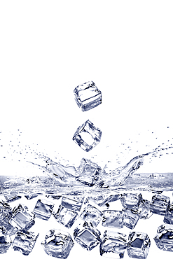 Falling ice cubes splashing into water and floating