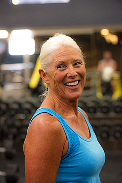 Smiling older woman working out in gymnasium