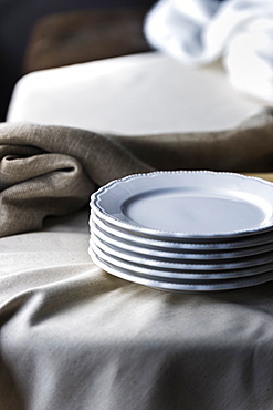 Stack of plates on tablecloth